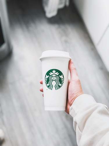 coffee cup person holding white Starbucks disposable cup cup